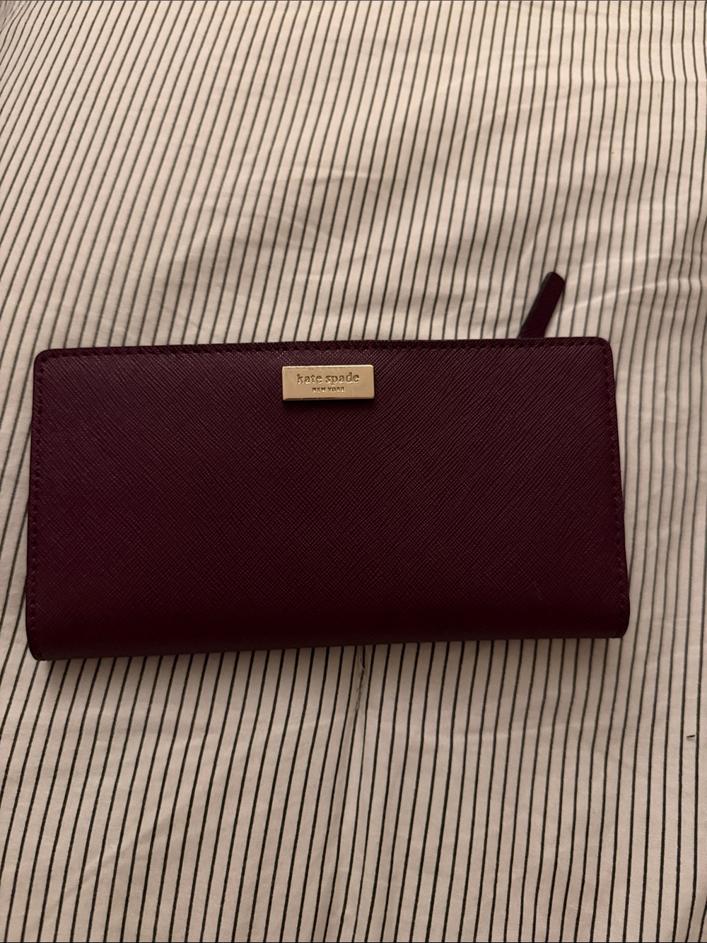 kate spade plum zip-around saffiano wallet with gold plaque